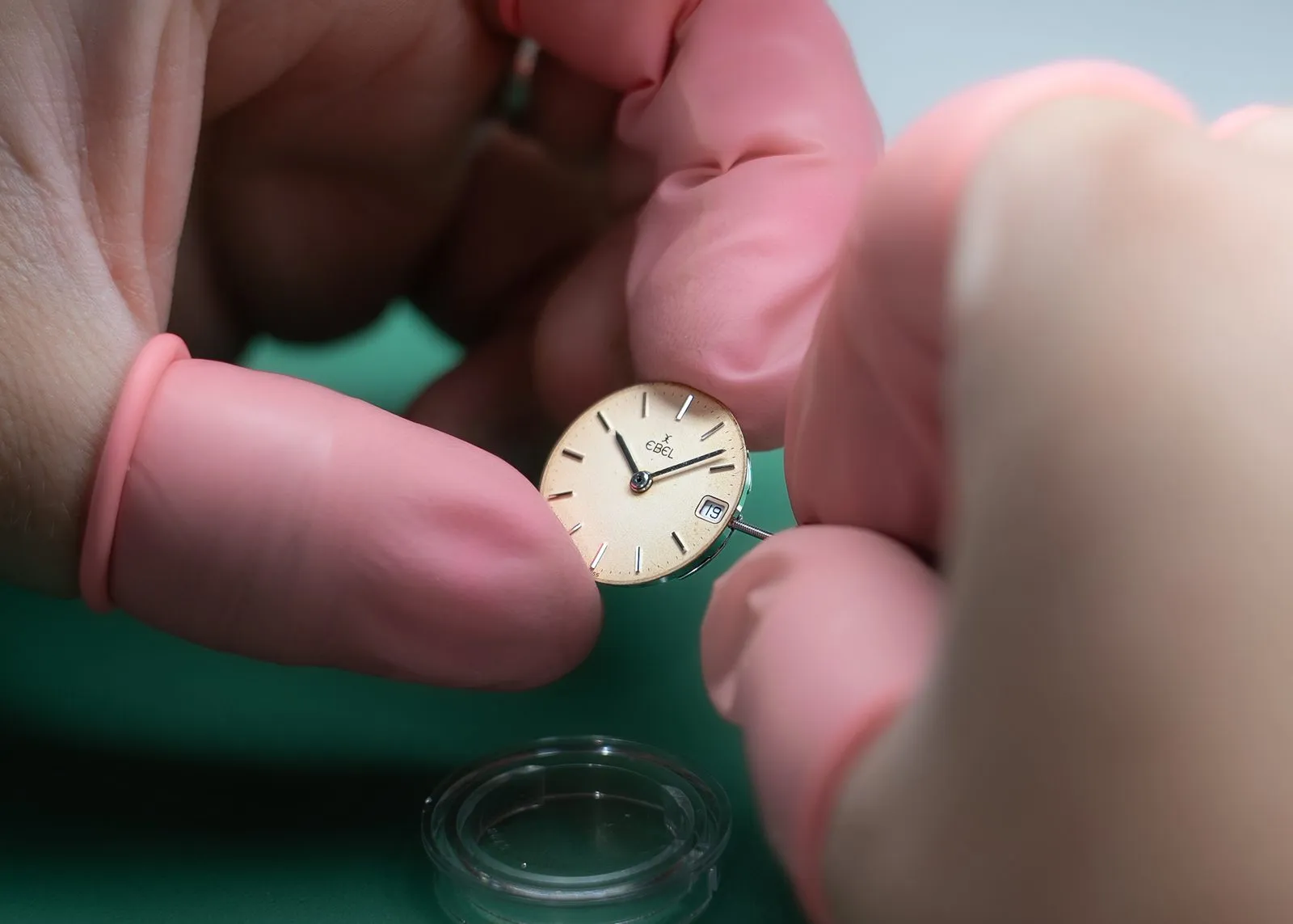 SwissMade watchmaker holding an Ebel dial during basic maintenance