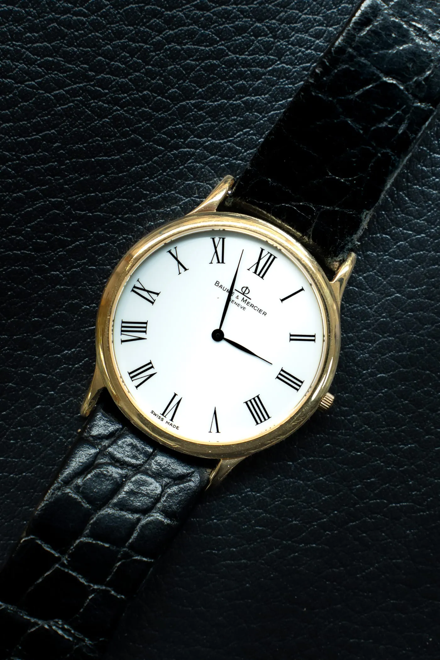 Gold Baume & Mercier dress watch with white Roman numeral dial