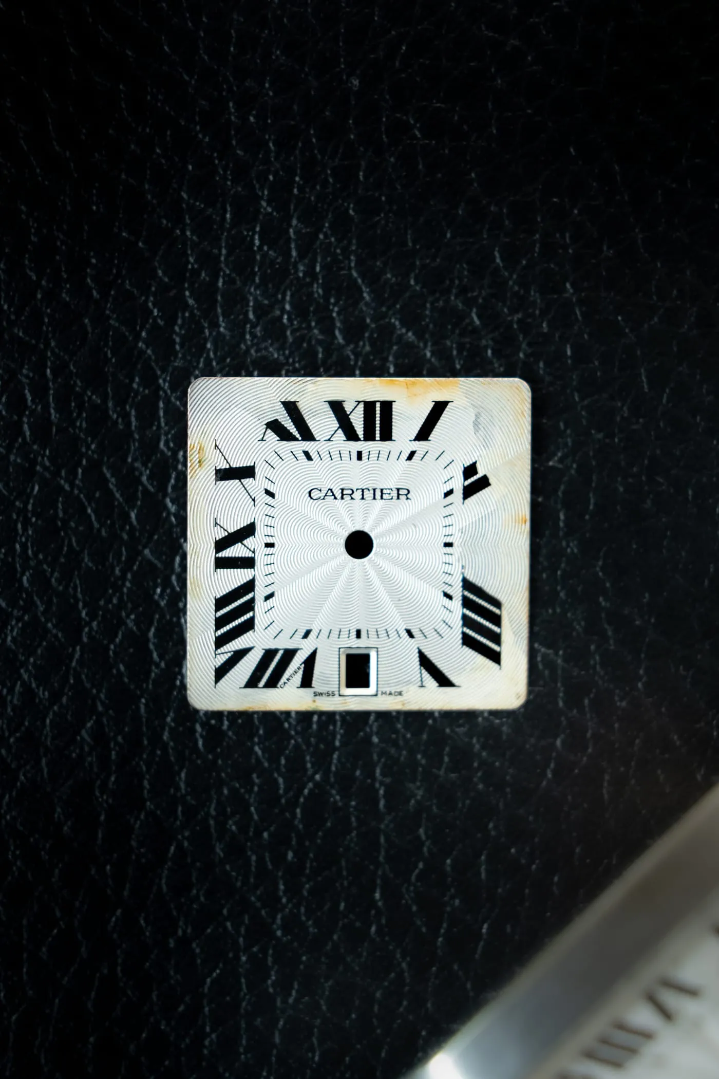 Cartier dial removed for restoration, showing age marks at the edges