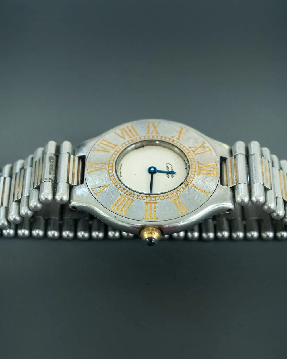 Vintage two-tone Cartier with a Roman numeral bezel on its bracelet, in for restoration at SwissMade