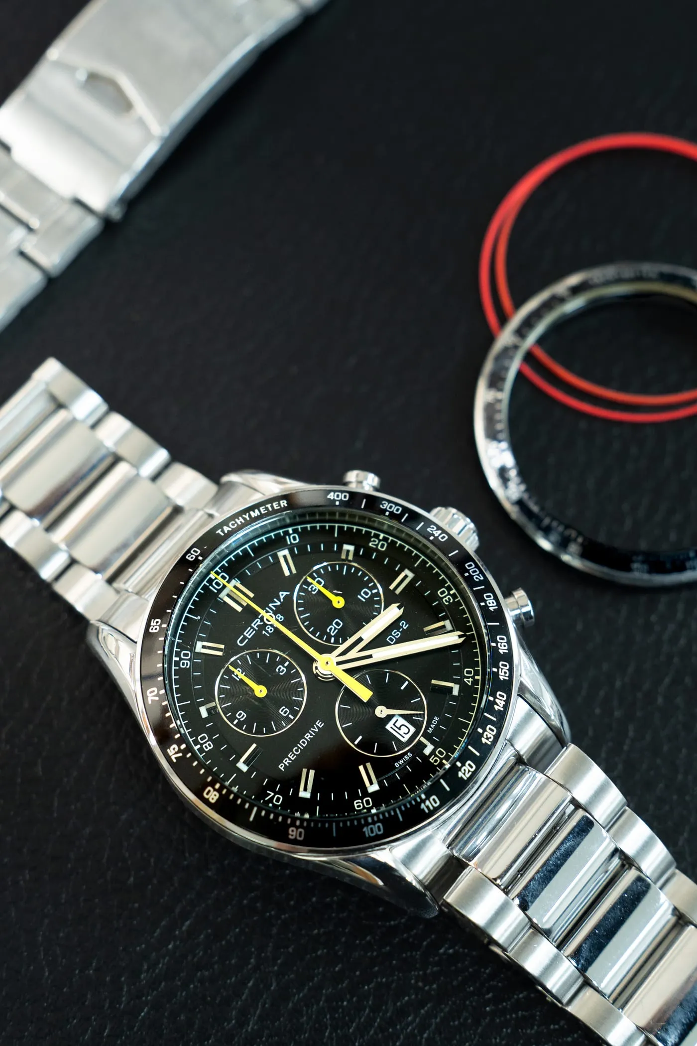 Certina DS-2 Precidrive chronograph beside its removed bezel on the SwissMade bench