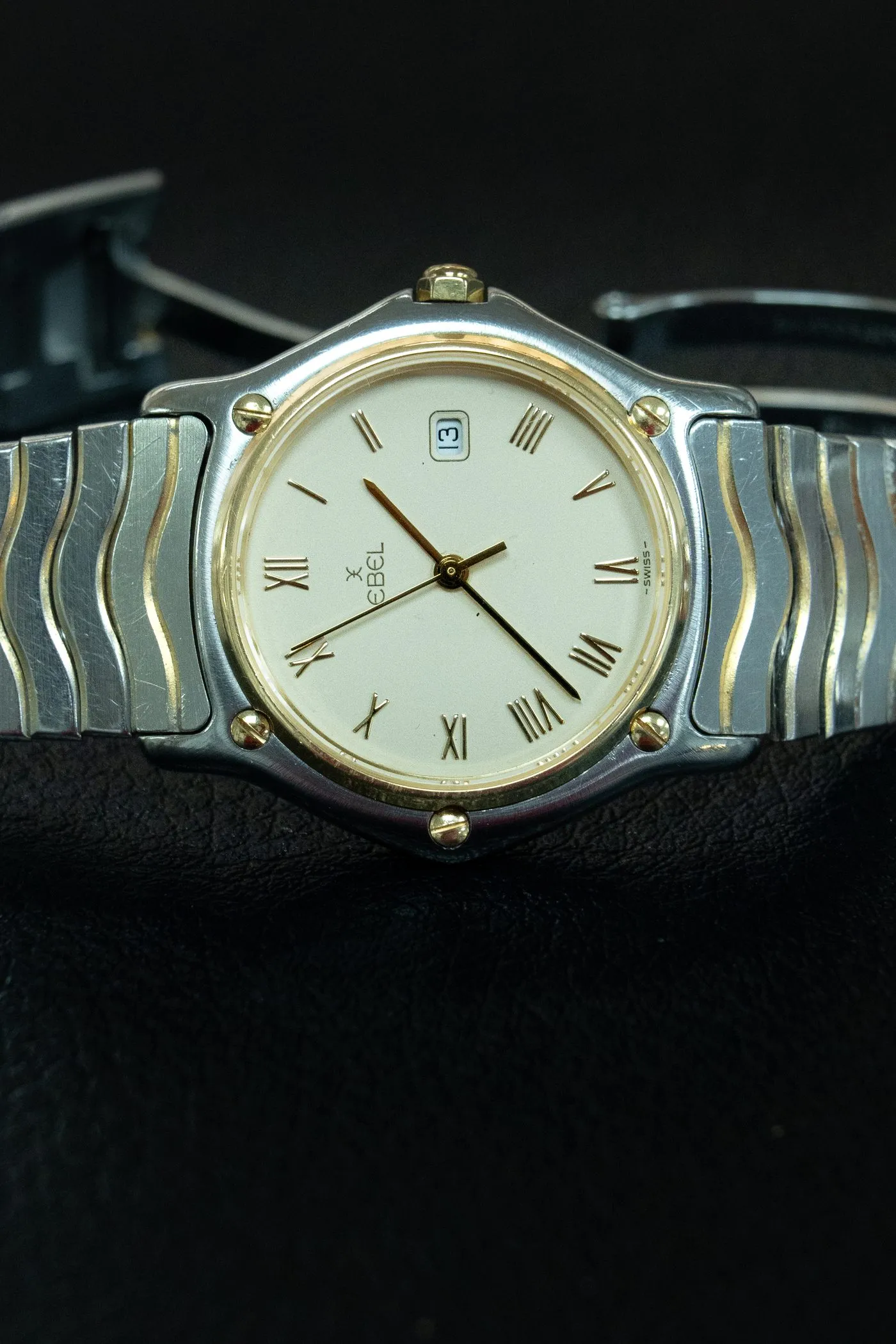 Two-tone Ebel Classic Wave with a cream Roman numeral dial, photographed at SwissMade