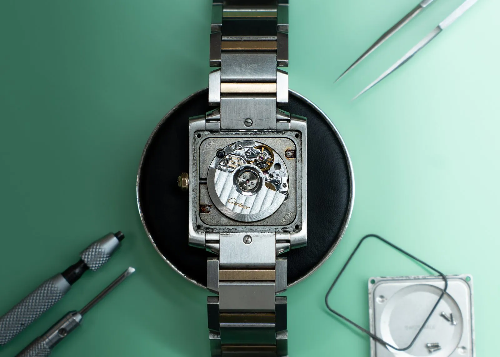 Cartier Tank with its caseback removed ahead of refurbishment and polishing at SwissMade