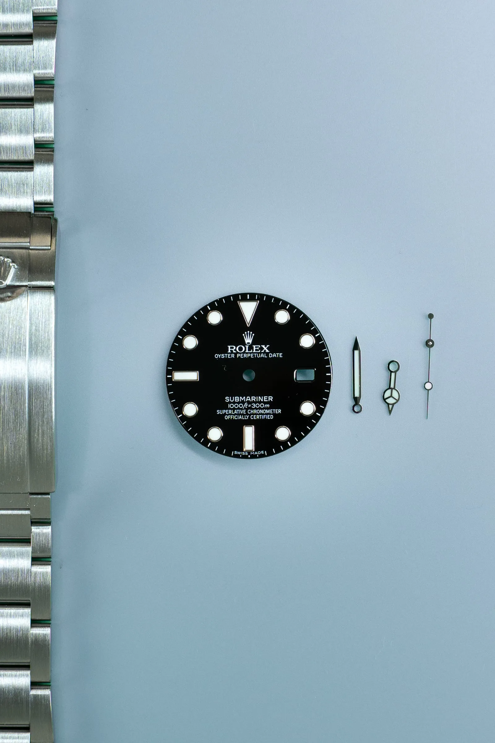 Vintage Rolex Submariner dial and bracelet on the bench during assessment