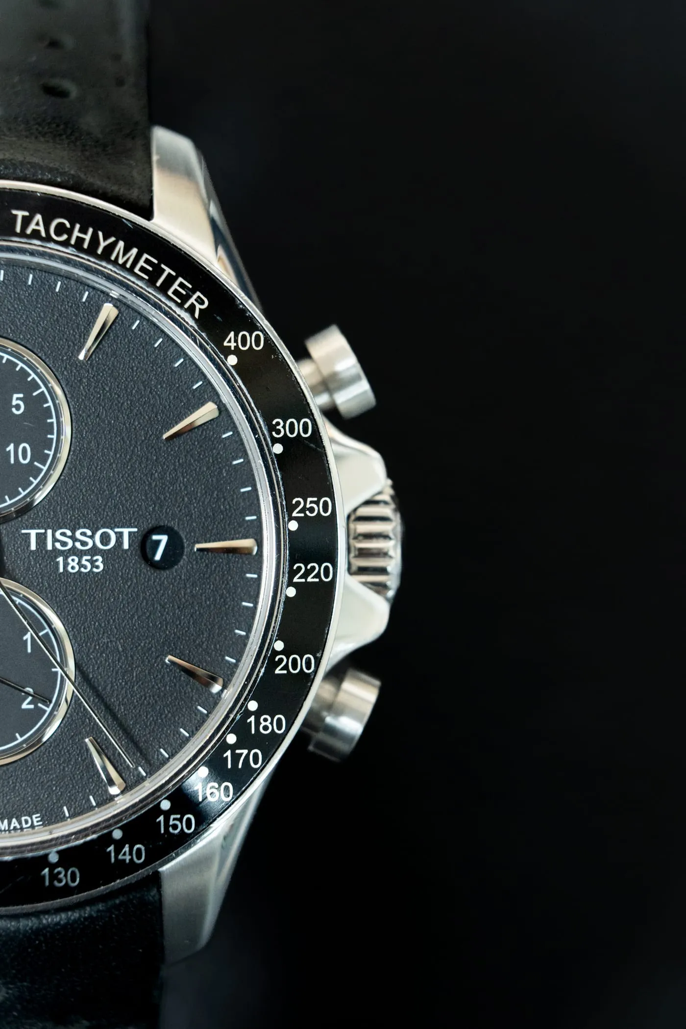 Close-up of a Tissot chronograph with black dial and tachymeter bezel