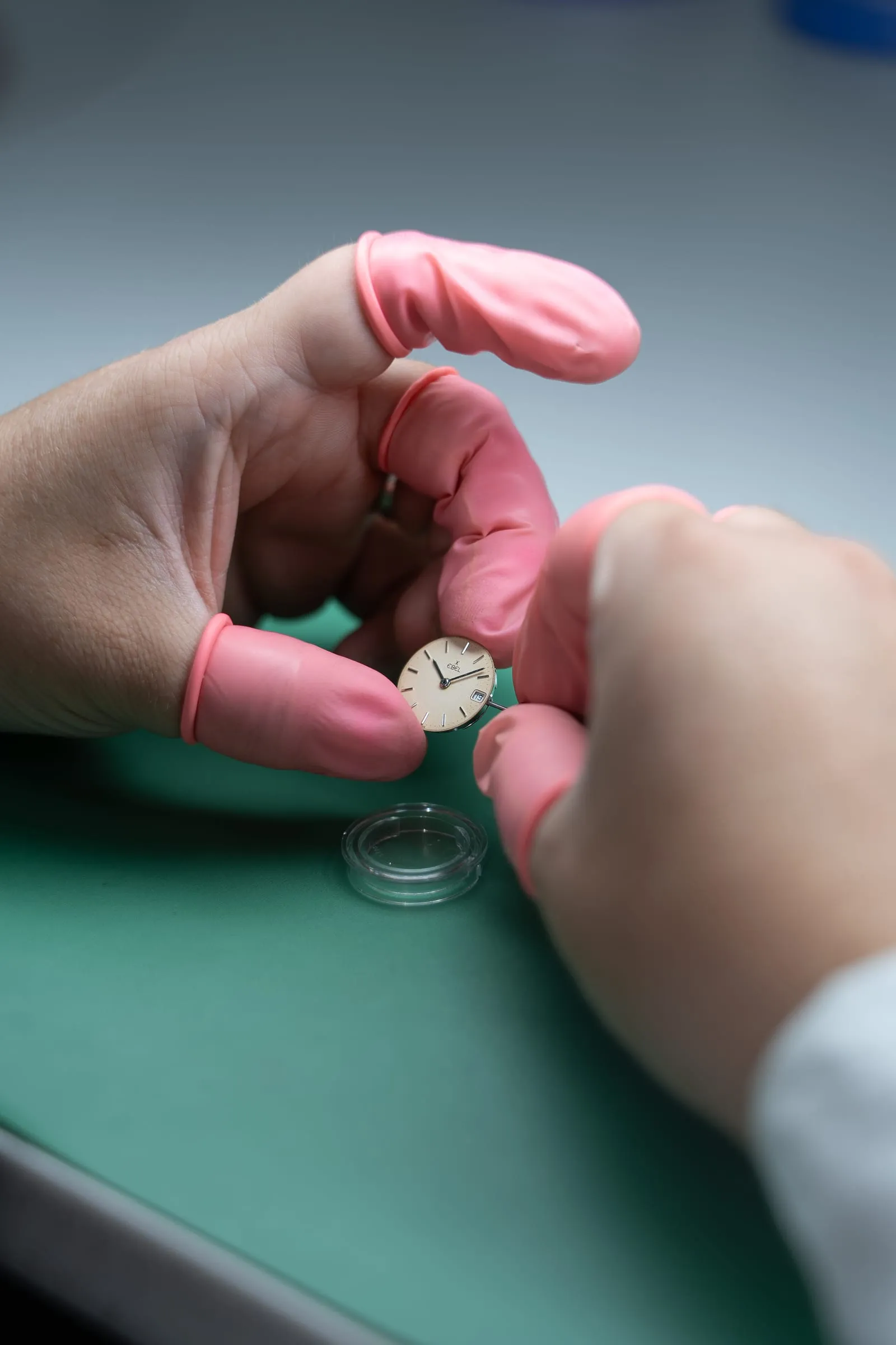 Watchmaker checking a dial during basic maintenance at SwissMade