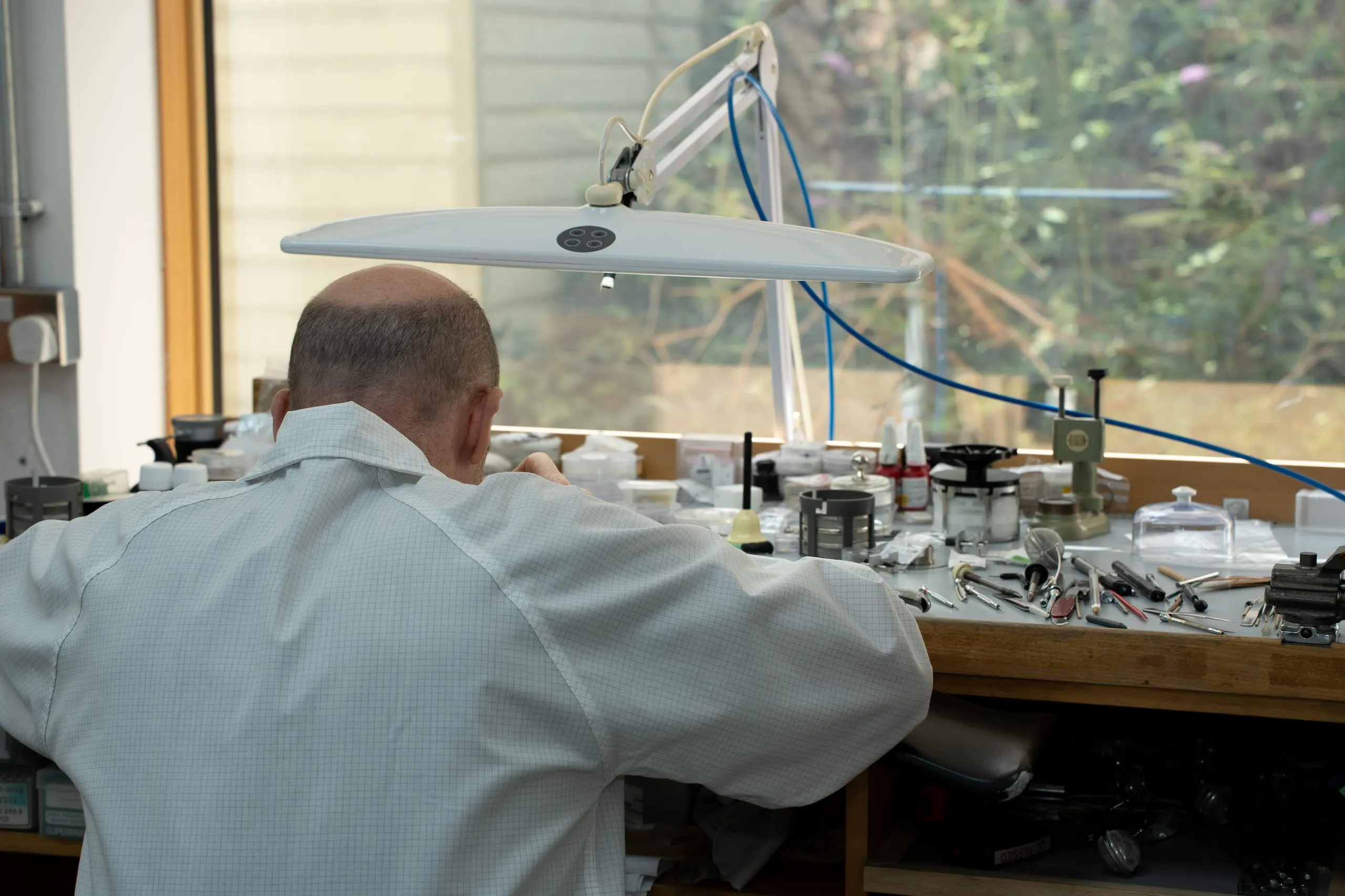 SwissMade watchmaker at the window bench in the Hatton Garden workshop